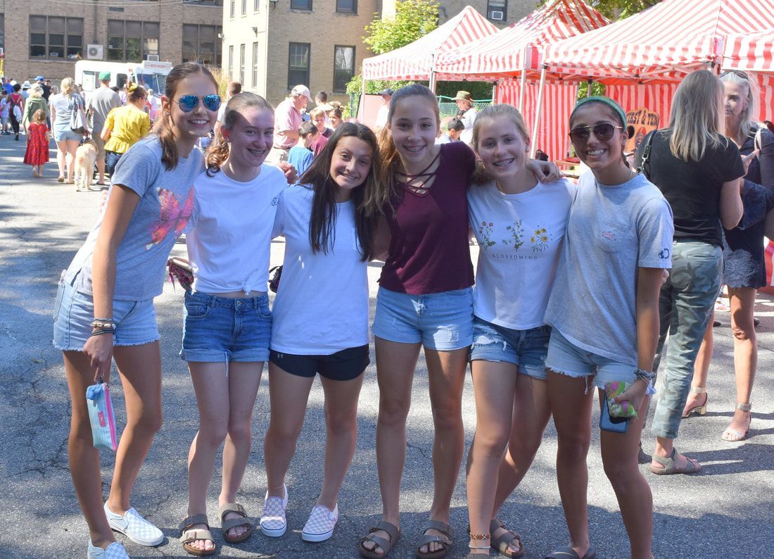 A group of young girls are posing for a picture together