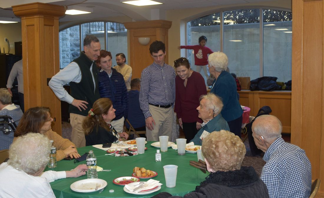 A group of people are sitting around a table eating food