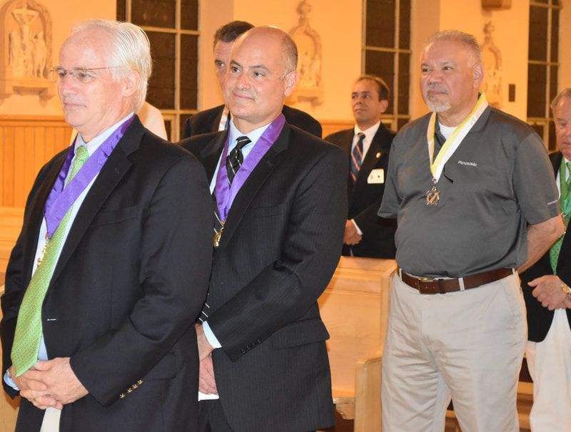 A group of men in suits and ties are standing in a line