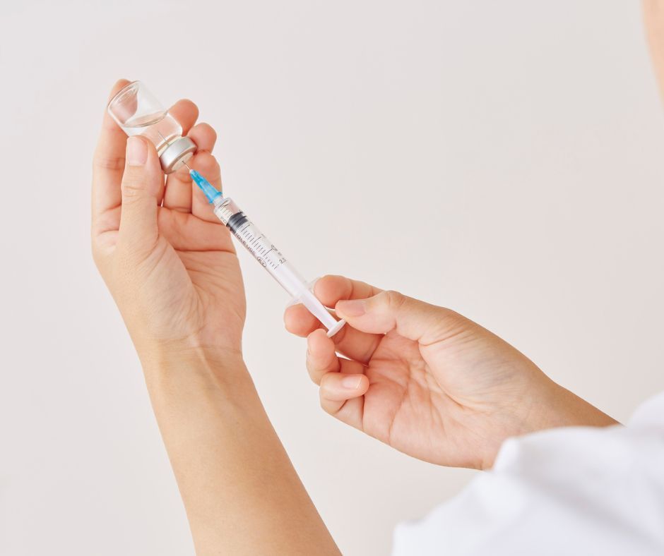 A pharmacist preparing a Vitamin B12 injection at Pearlfect Care Pharmacy