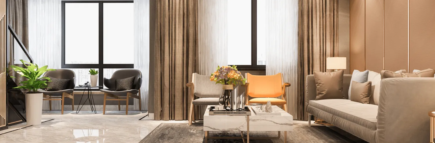 A bright, modern living room featuring a sofa, two chairs, a central coffee table, and large windows with brown curtains.