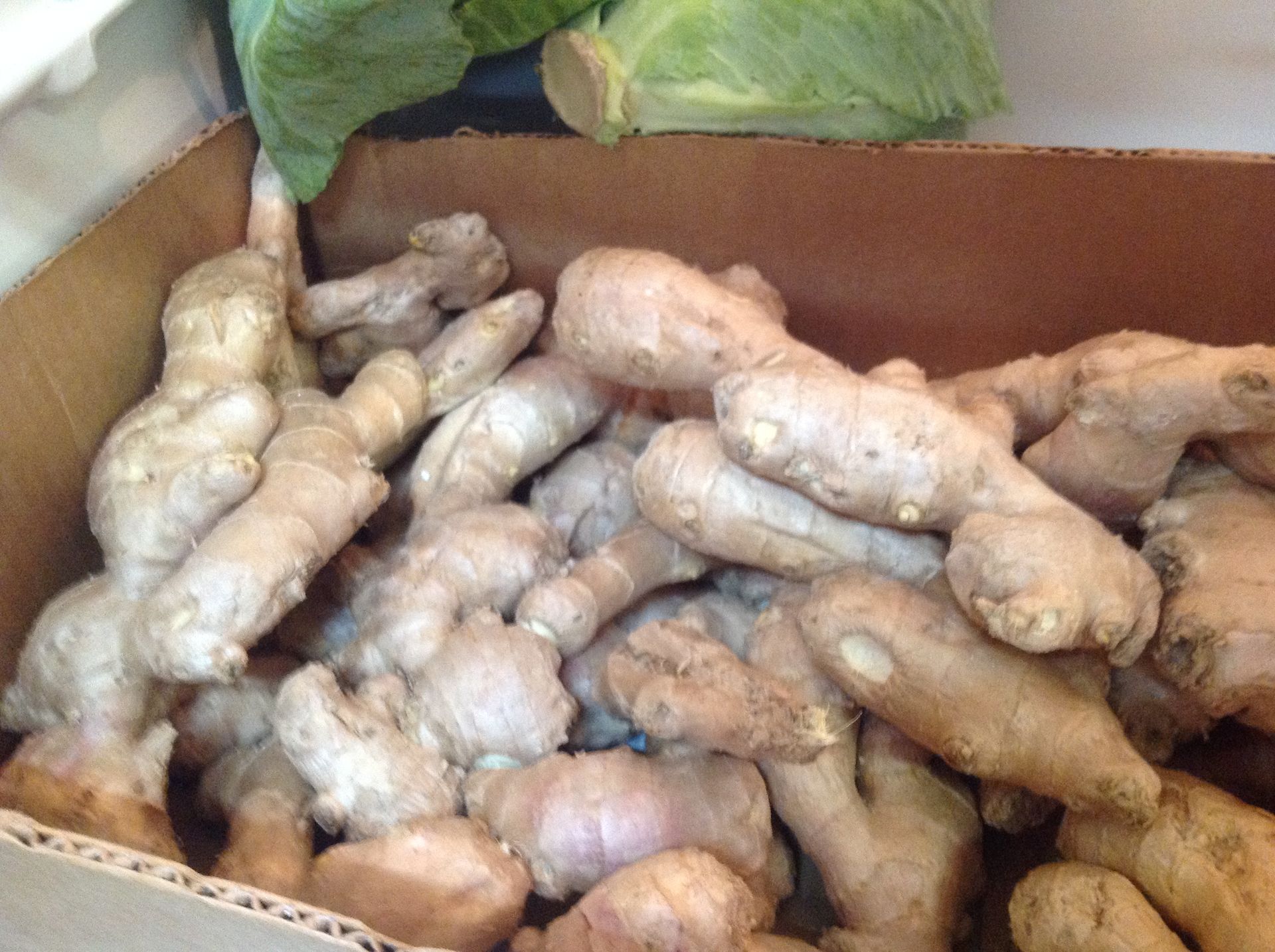 Box of fresh ginger roots.