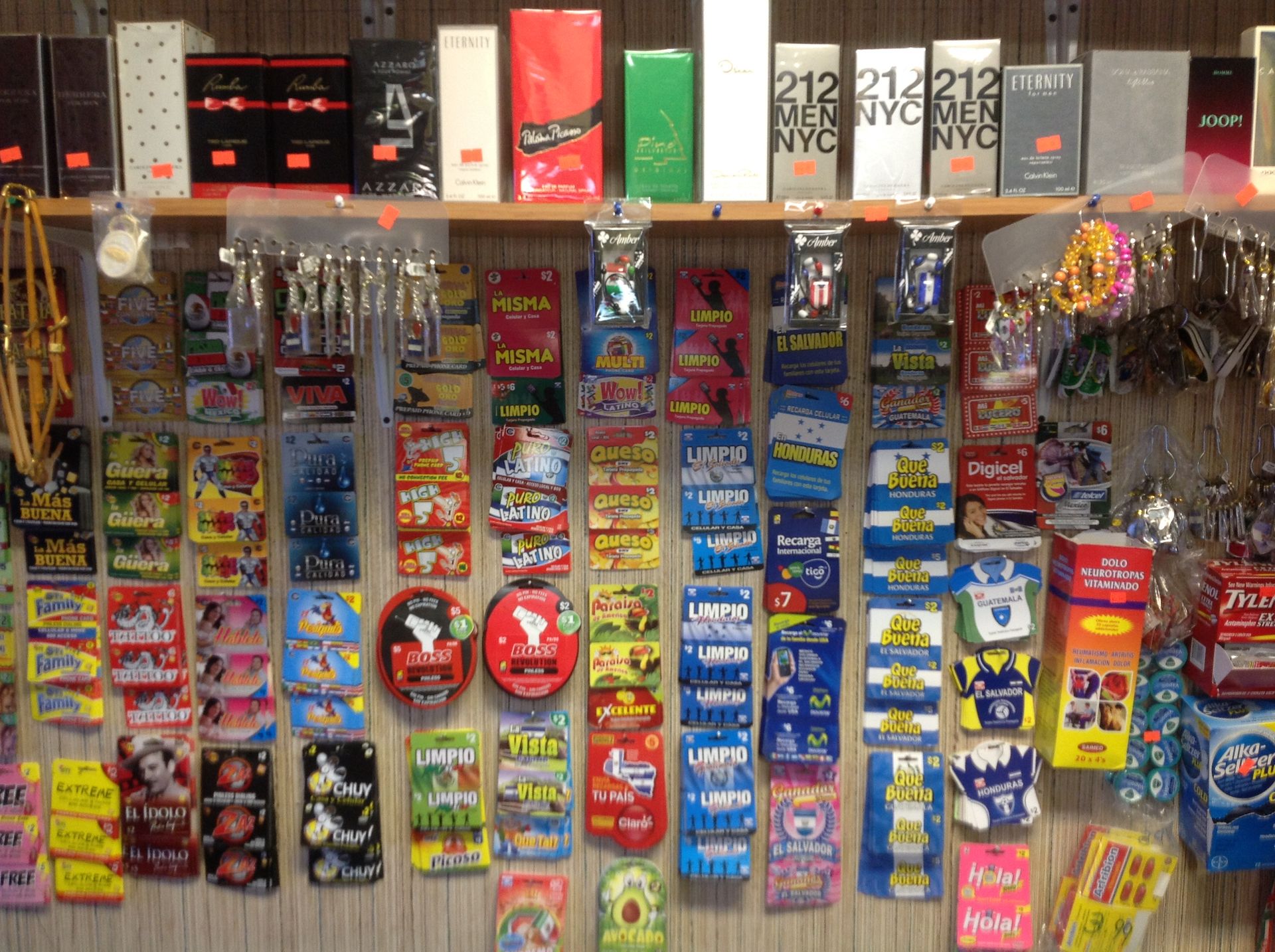 Shelves with perfumes above and candy displays below. Various shapes, sizes, and colors are visible.
