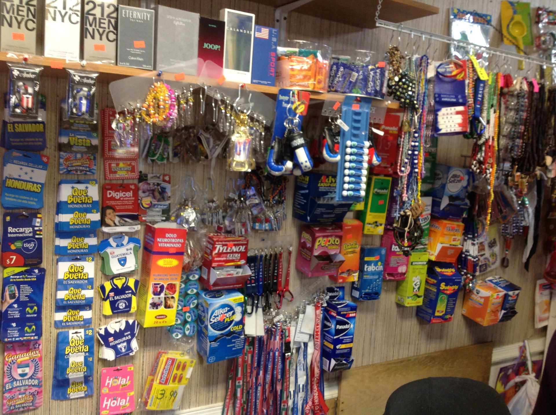 A store display with various packaged products: keychains, candies, and toiletries.