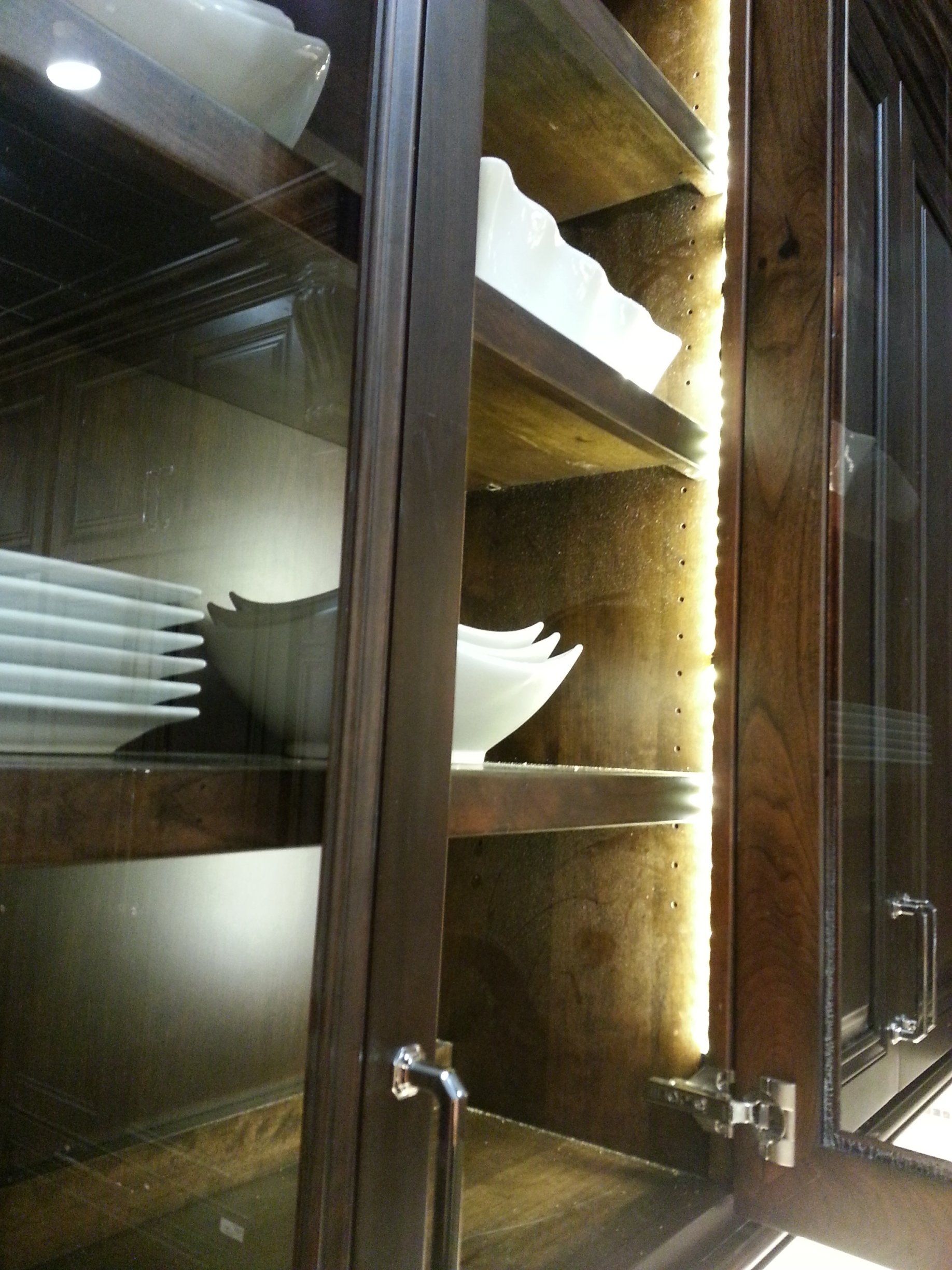 Glass door kitchen cabinets with LED strip lights rope lights.