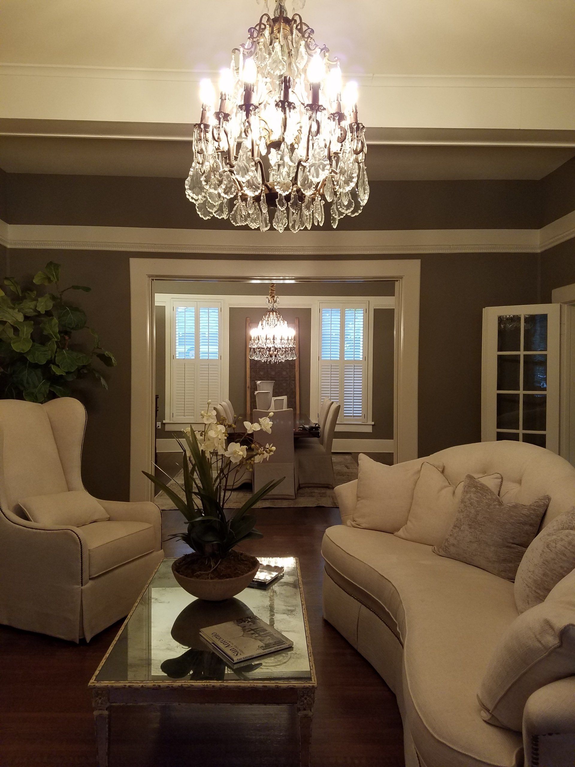 Custom chandelier lighting install in cozy living room.