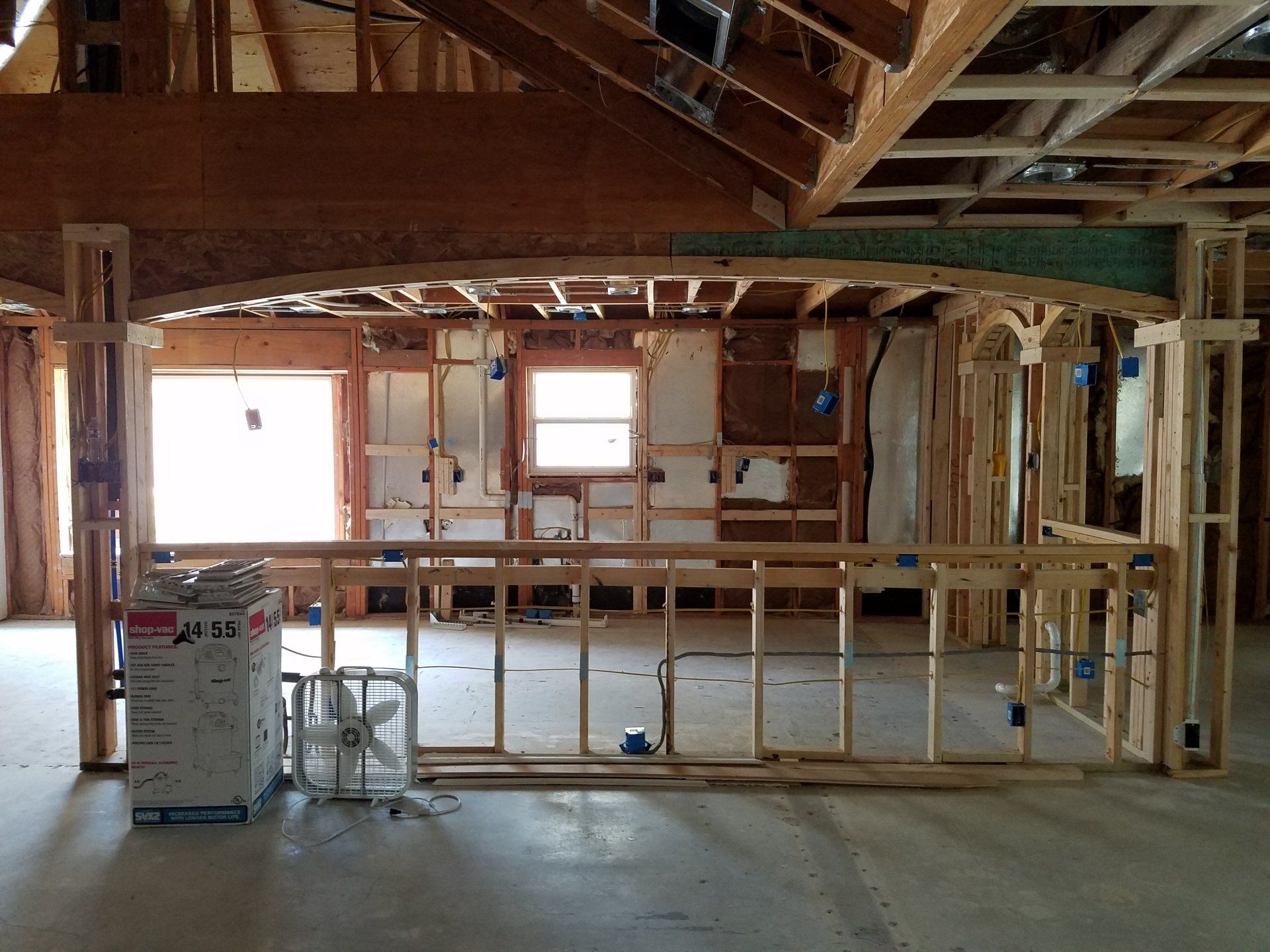 Installing electrical junction boxes and conduit in the framing during construction. 