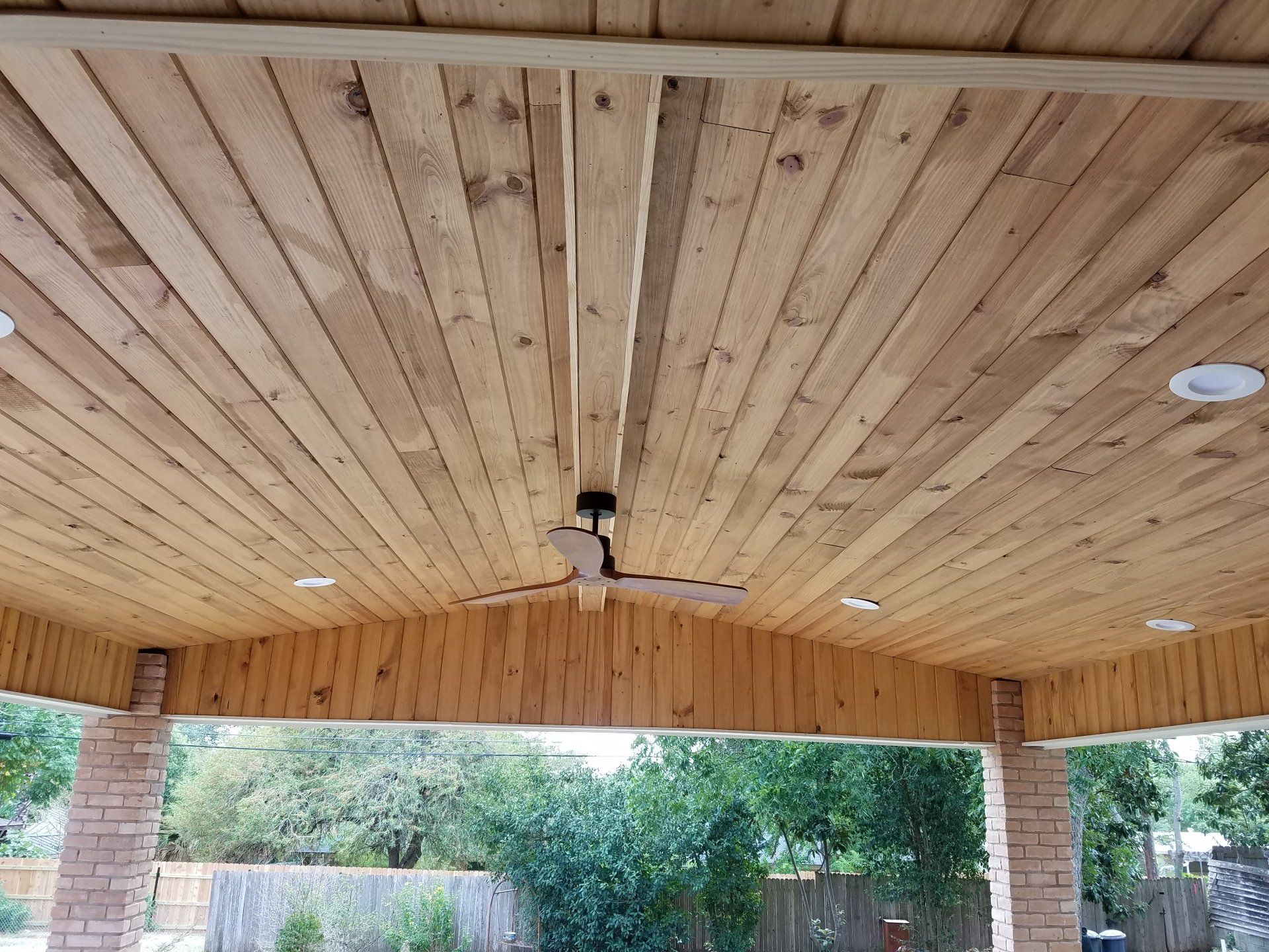 Exterior ceiling fan installation on a covered patio 