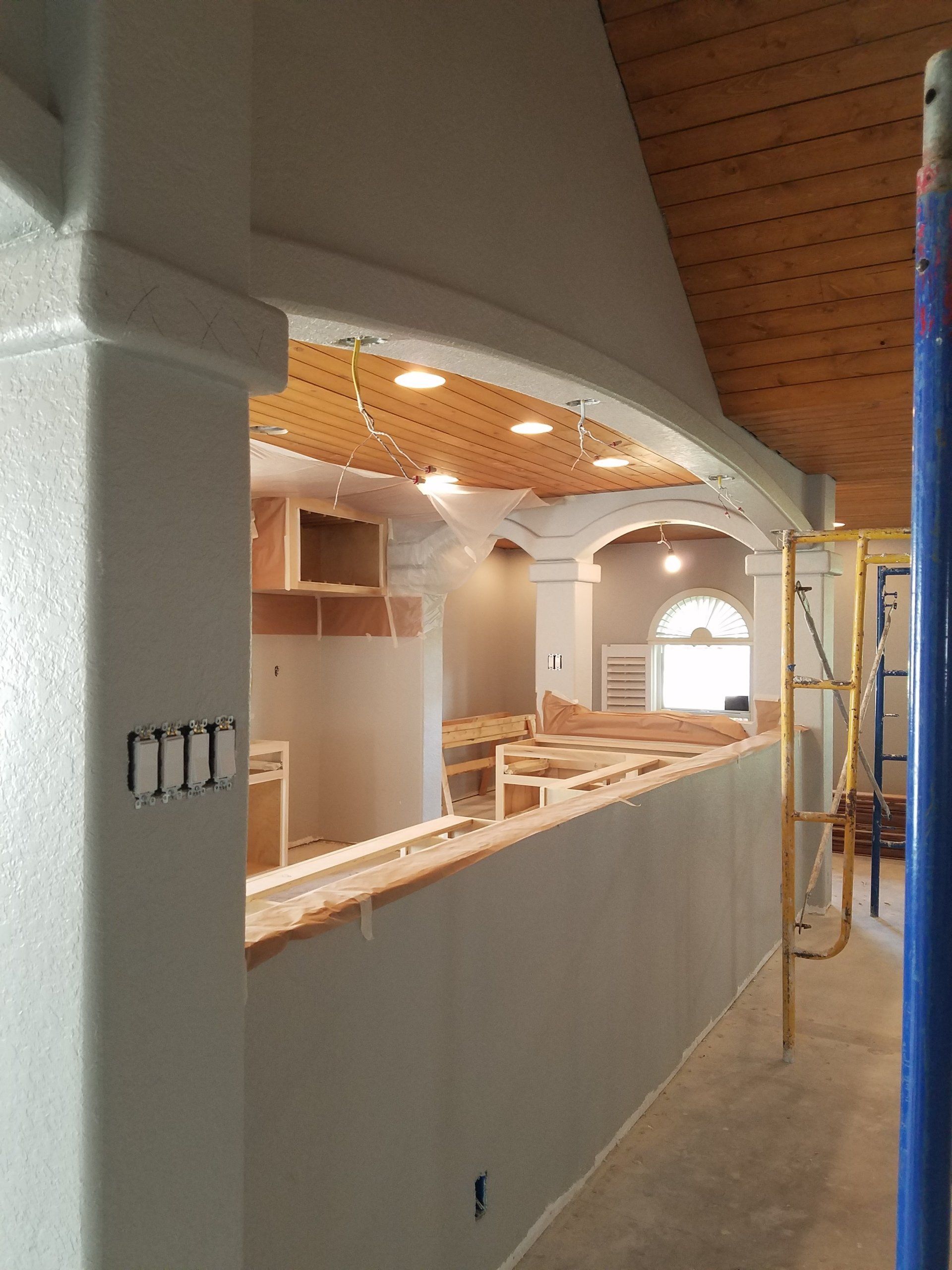 Adding recessed lighting in the kitchen during the construction phase.