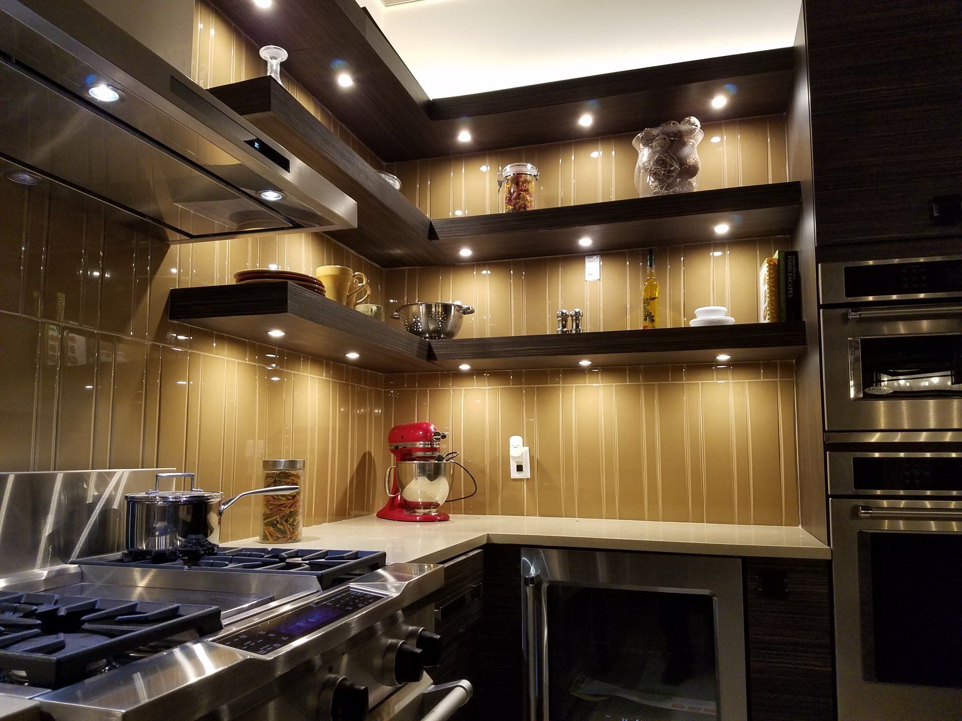 an elegant kitchen with modern design elements and updated in-shelf ambient lighting. 
