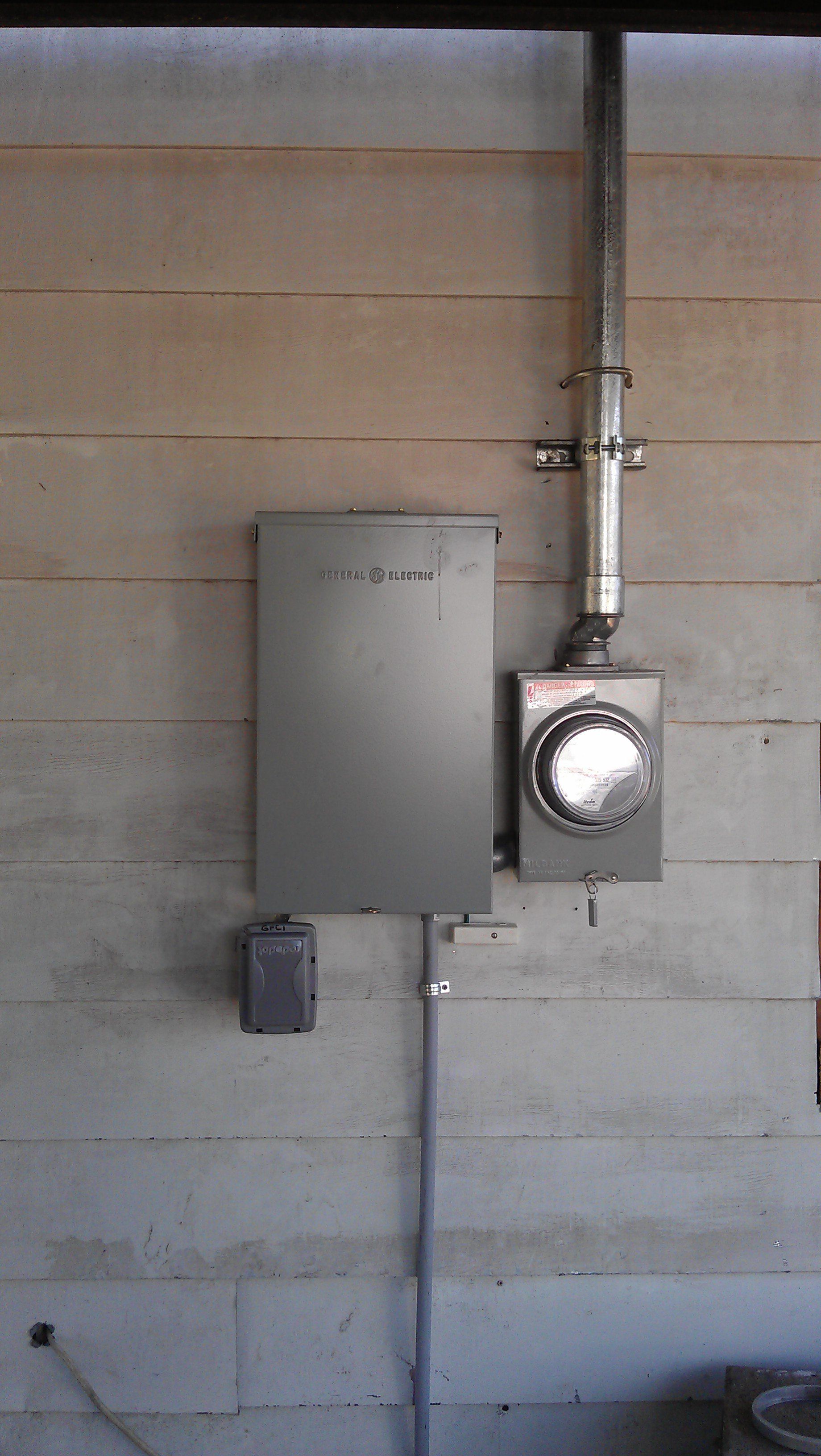 Electrical enclosure box next to the electrical meter. 