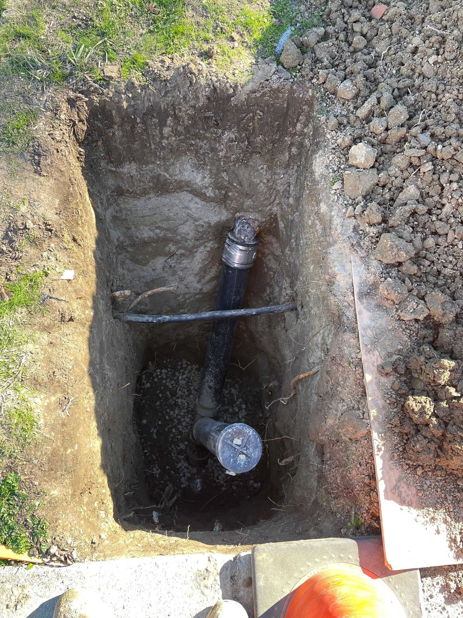 A pipe is being installed in a hole in the ground.