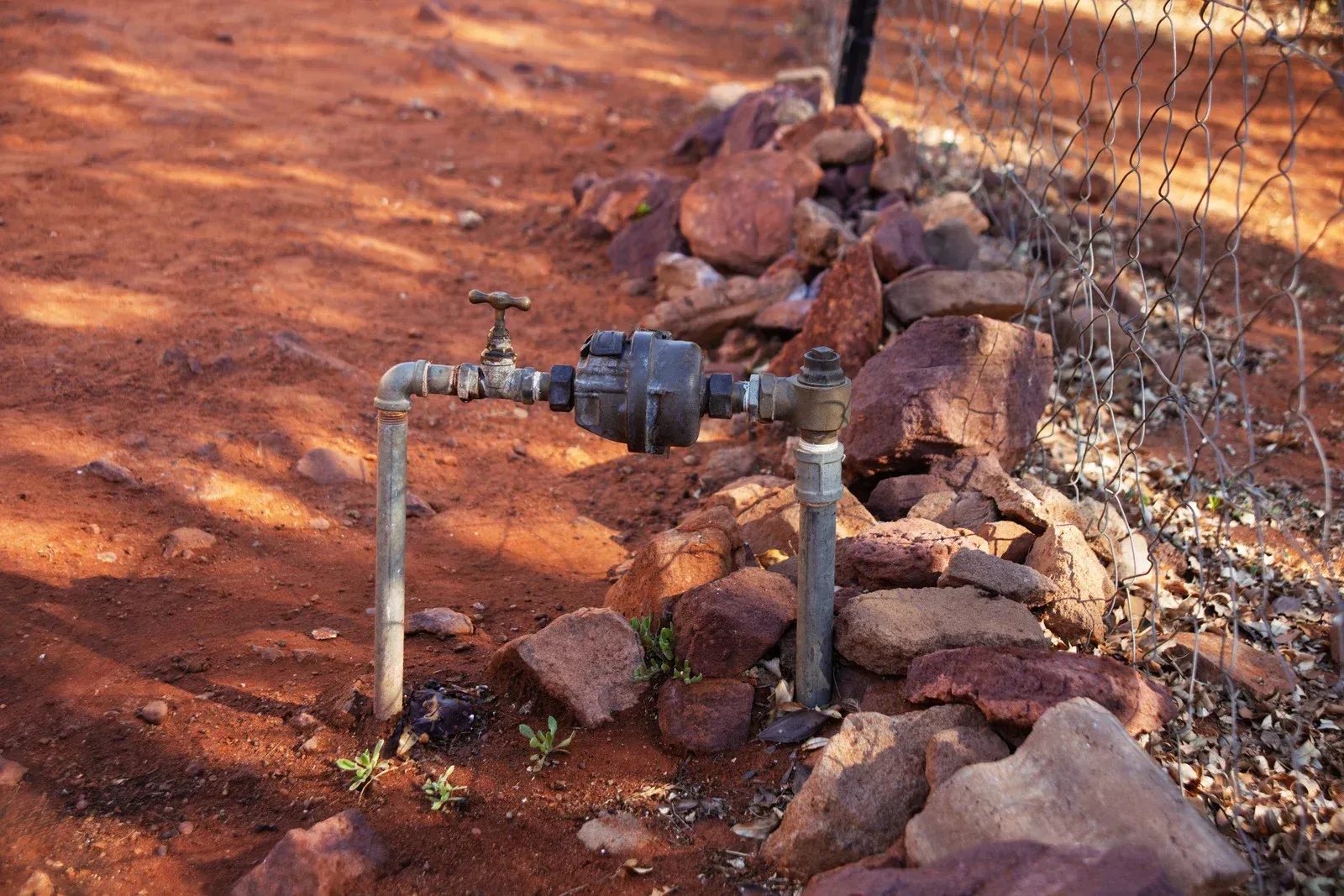 A man is taking notes on a clipboard while a woman sits on a couch.