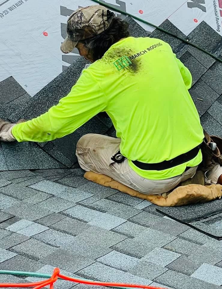 Worker performing shingle installation.  Man installing Shingles.  Local Shingle Installer.