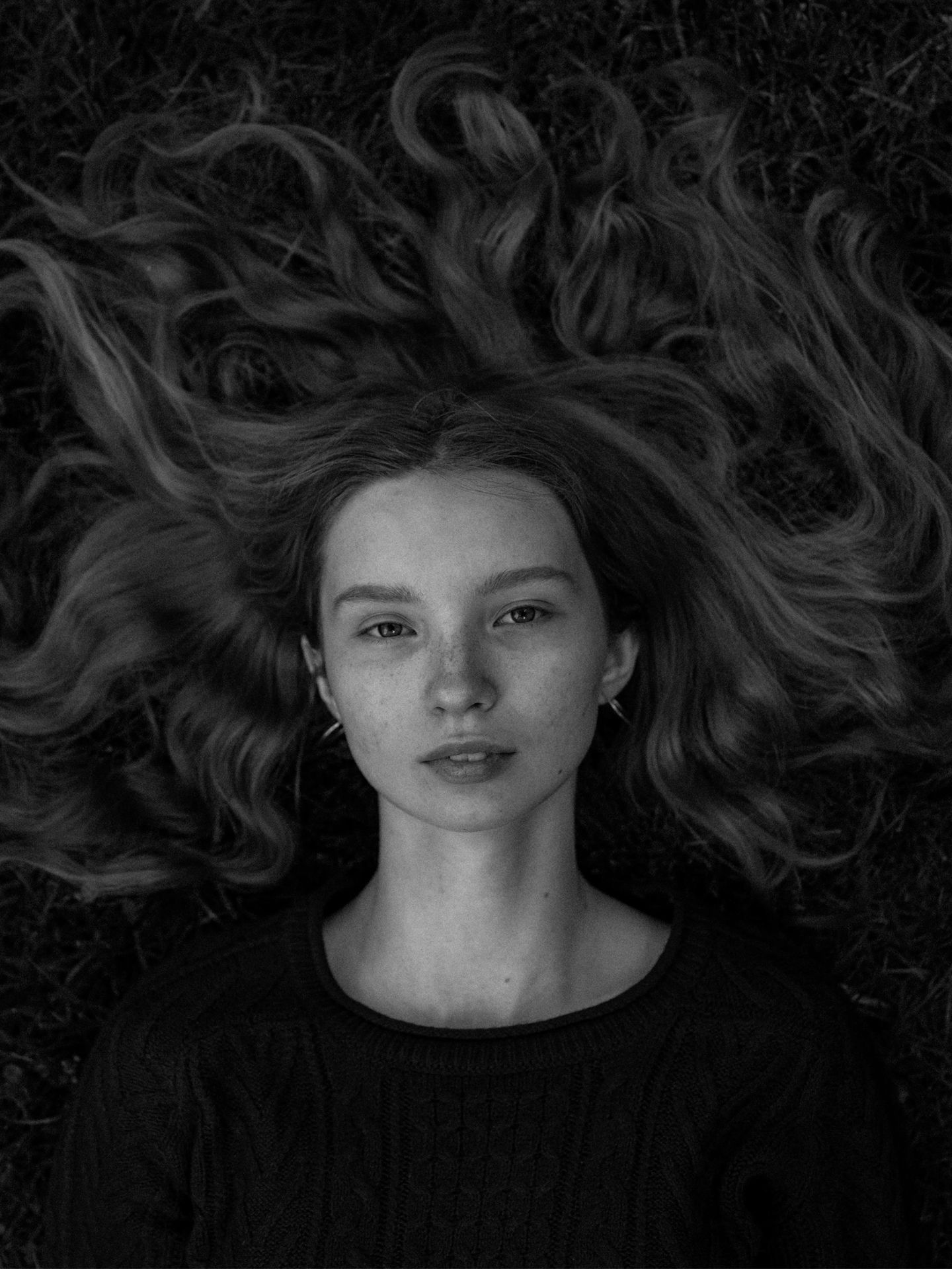 A woman with her curly hair blowing in the wind