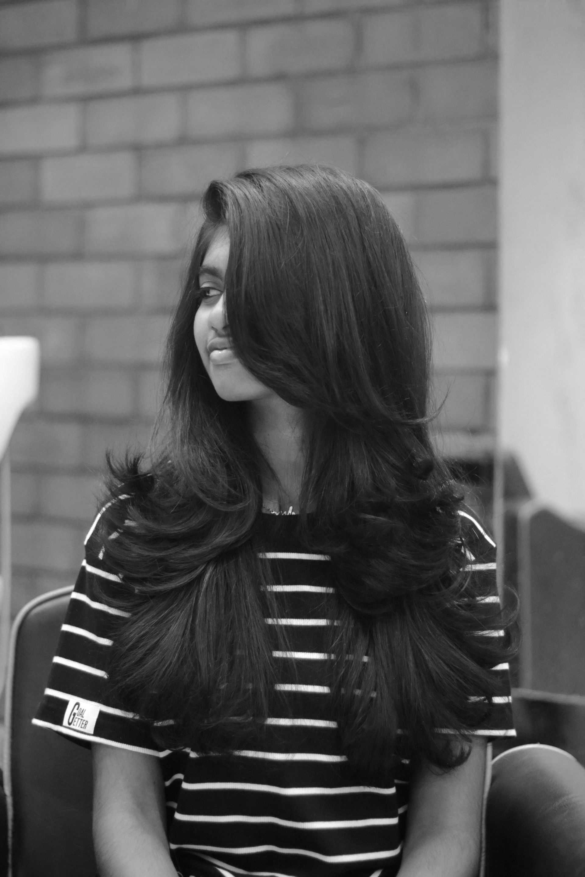 A woman with long hair sitting in a chair