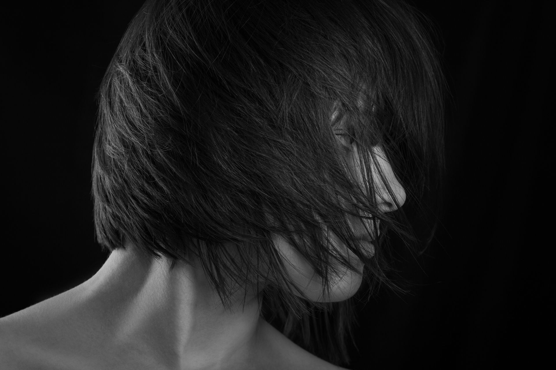 A woman with her hair blowing in the wind
