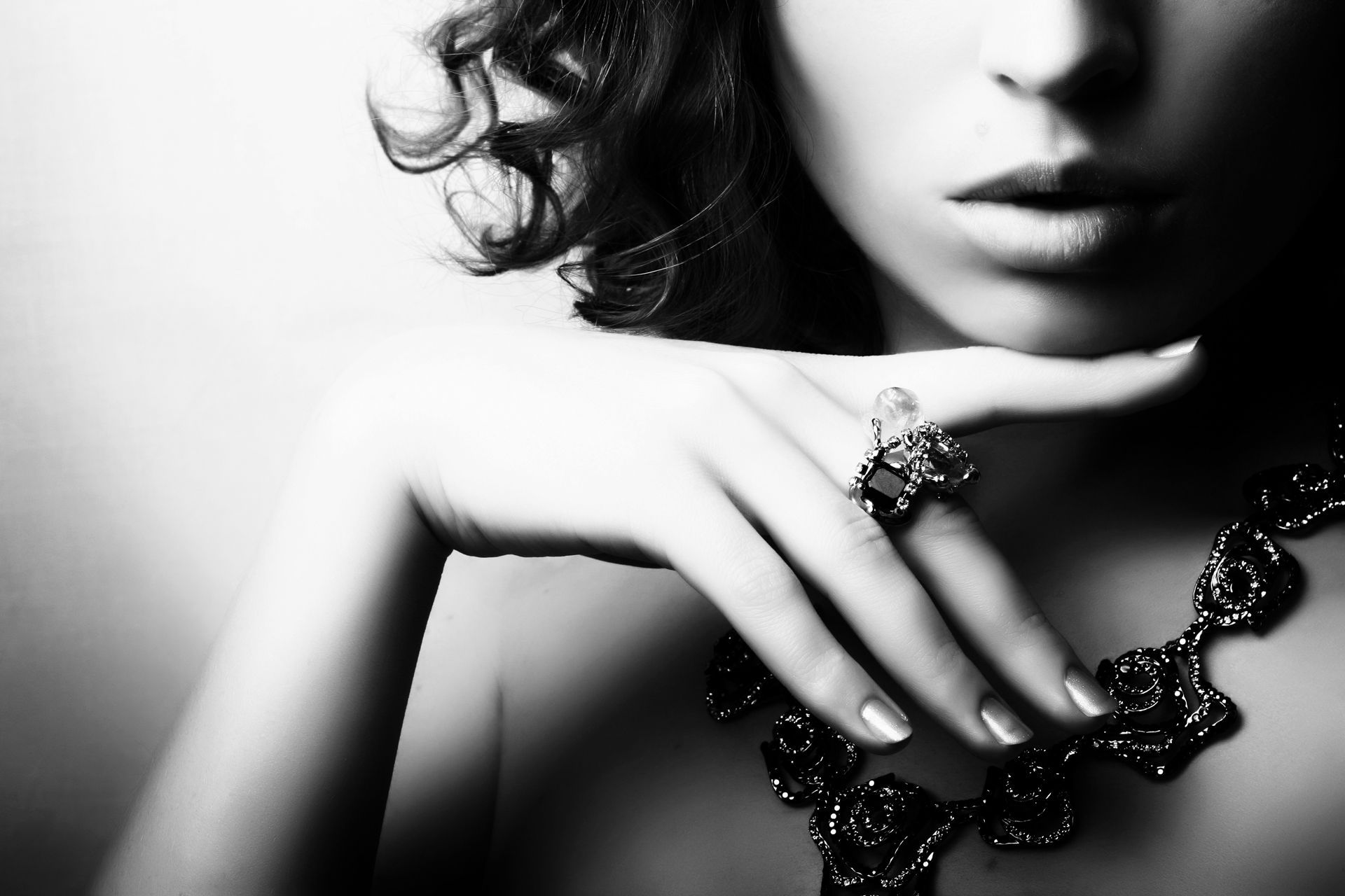 A black and white photo of a woman wearing a necklace