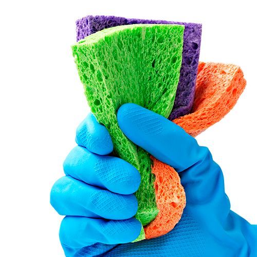 a person wearing blue gloves is holding three different colored sponges