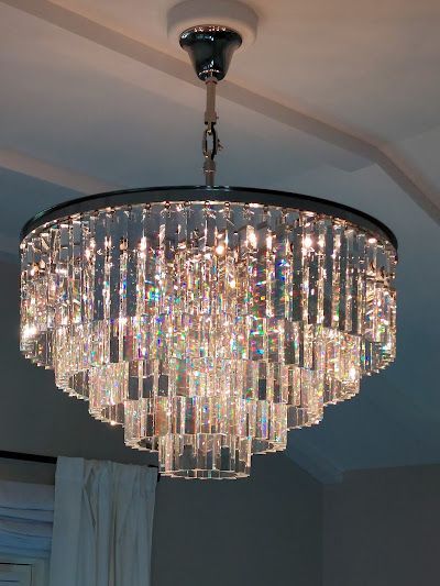 A chandelier is hanging from the ceiling in a room