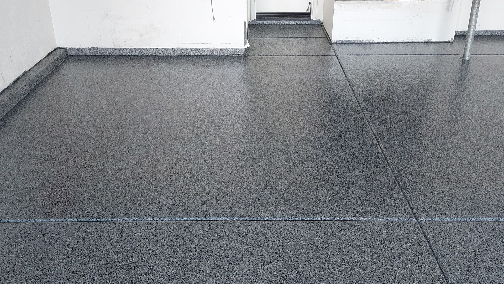 A close up of a black and white floor in a room.