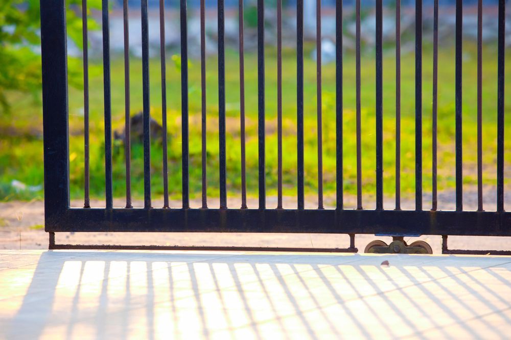 A Black Sliding Gate Is Open to A Grassy Field — Fence Factory In Palmerston, NT