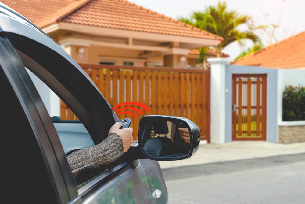 A Person is Driving a Car and Using a Remote Control to Open a Gate — Fence Factory In Berrimah, NT