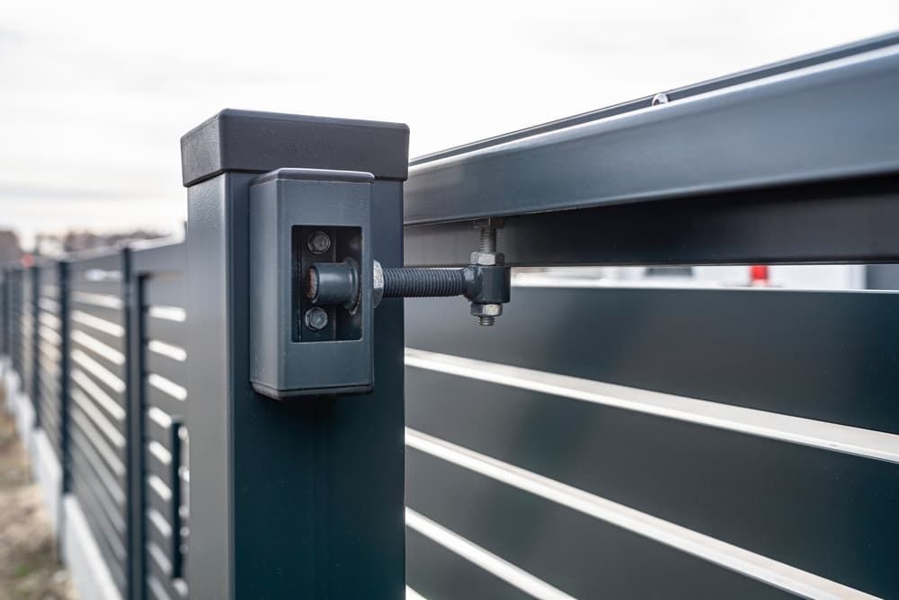 A Close up Of A Black Fence with A Sliding Gate — Fence Factory In Kununurra, WA