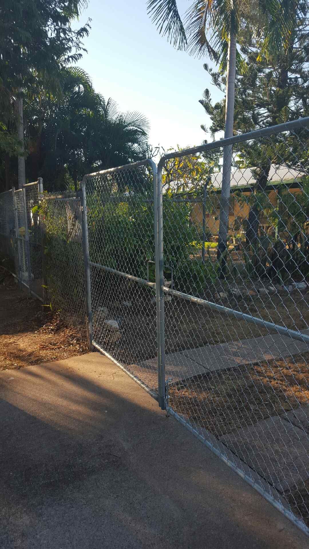 A Chain Link Fence with A Gate in Front of A House — Fence Factory In Berrimah, NT
