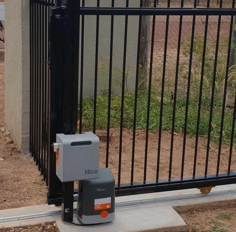 A Black Latch Is Attached to A White Fence Post — Fence Factory In Berrimah, NT
