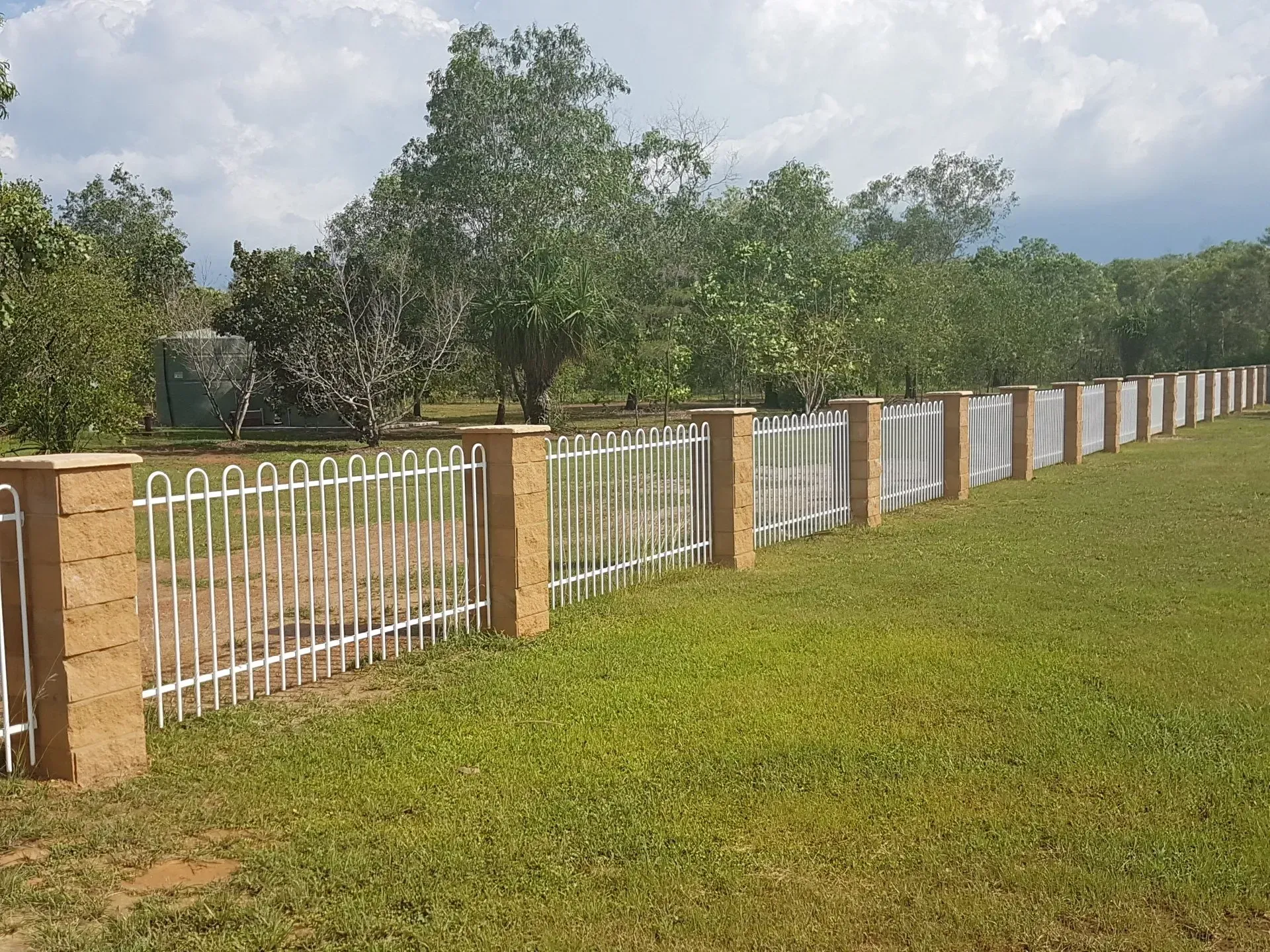 A long White Fence with brick pillars — Fence Factory In Tennant Creek, NT
