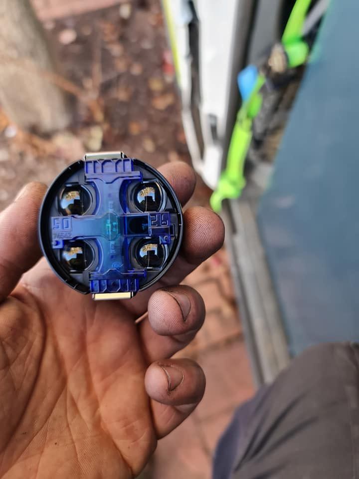 A Person Is Holding A Blue Object In Their Hand — Filip's Automotive in Crestwood, NSW