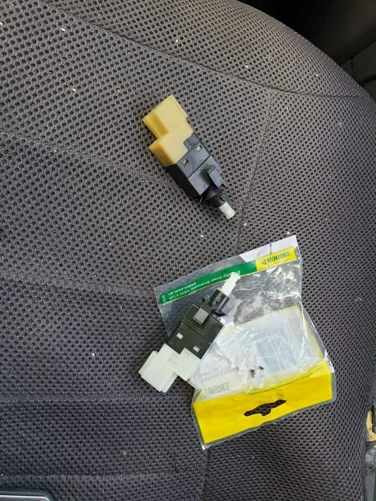 A Pair Of Switches Sitting On Top Of A Car Seat Next To A Package — Filip's Automotive in Crestwood, NSW