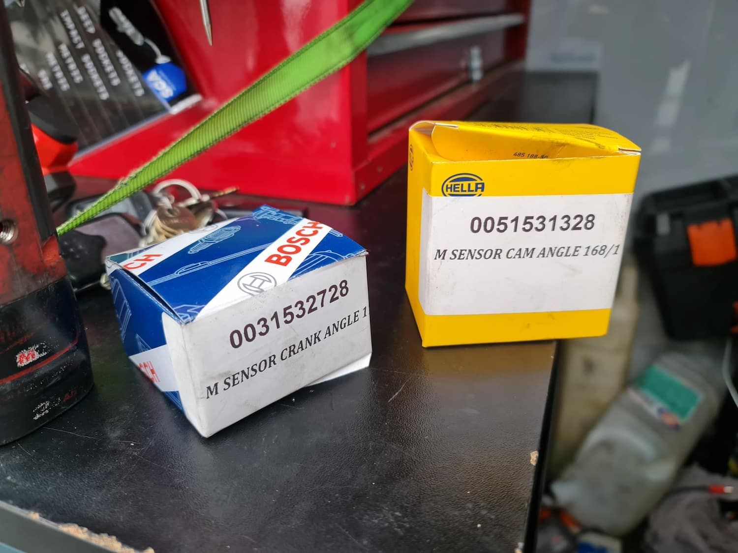 Two Boxes Of Bosch Parts Are Sitting On A Table — Filip's Automotive in Crestwood, NSW
