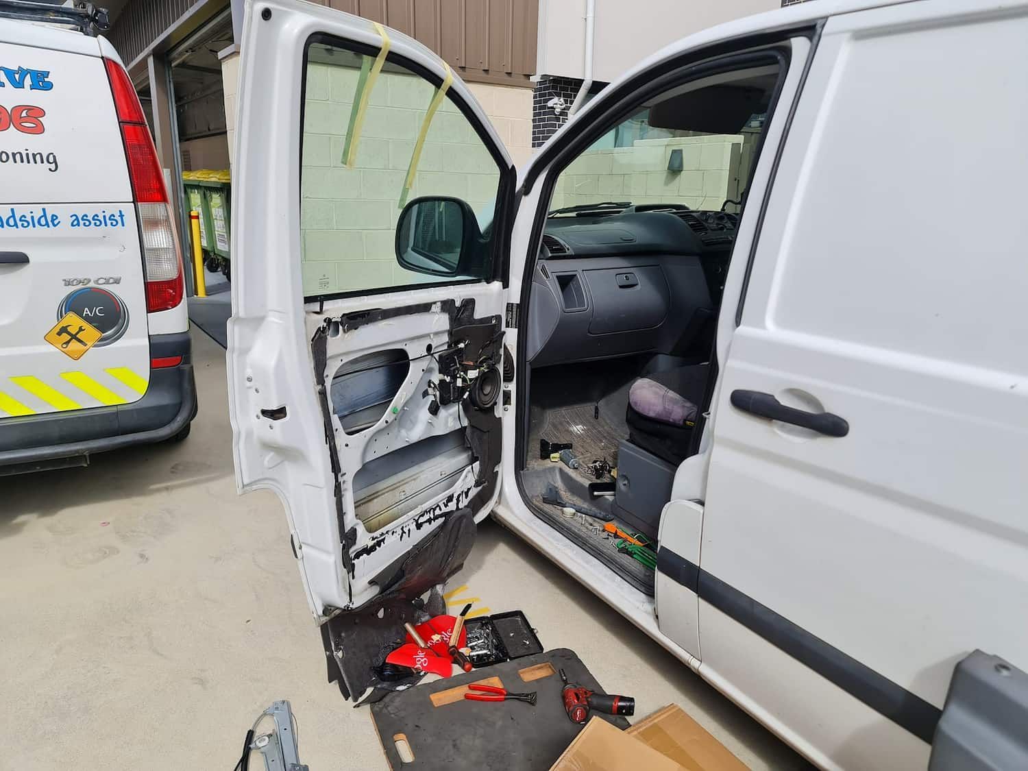 A White Van With Its Doors Open Is Being Repaired — Filip's Automotive in Crestwood, NSW