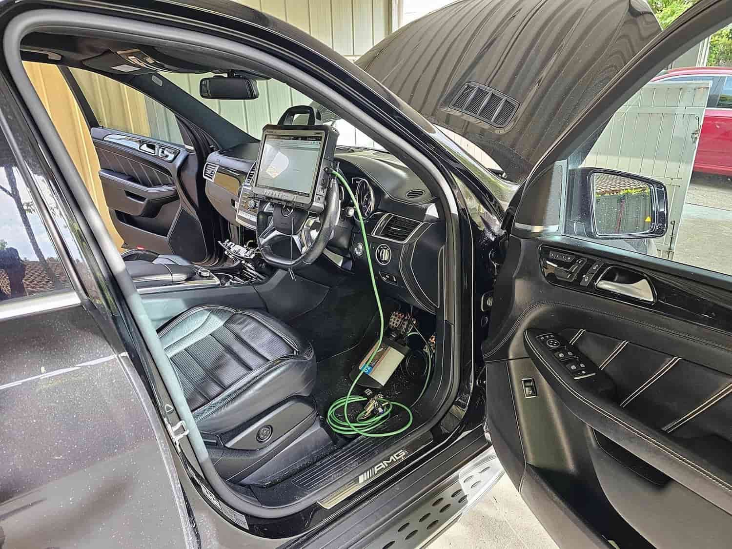 The Inside Of A Black Car With The Door Open And The Hood Up — Filip's Automotive in Crestwood, NSW