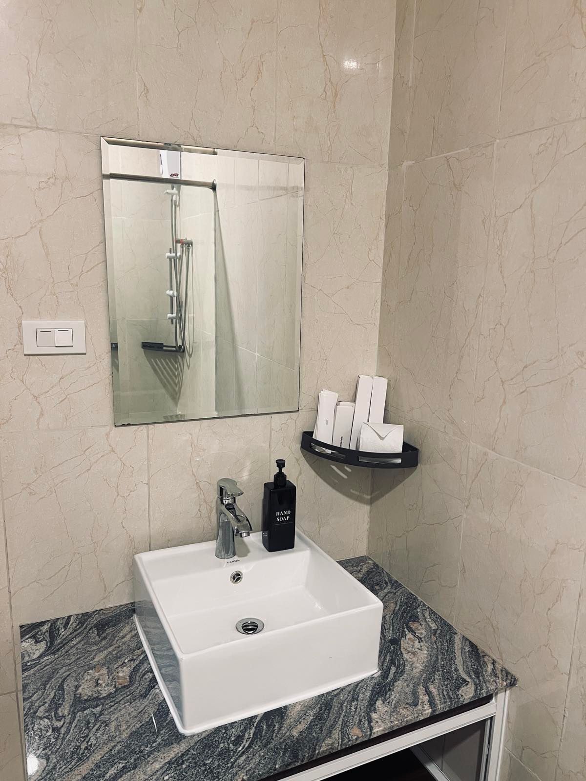 A bathroom with a sink and a mirror.