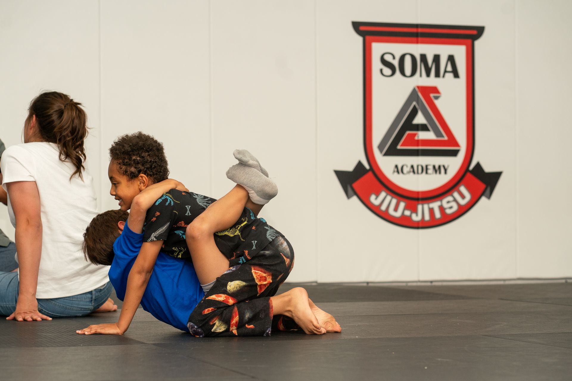 Students practicing controlled self-defense grappling at Soma Jiu-Jitsu Academy in Rexburg, ID.