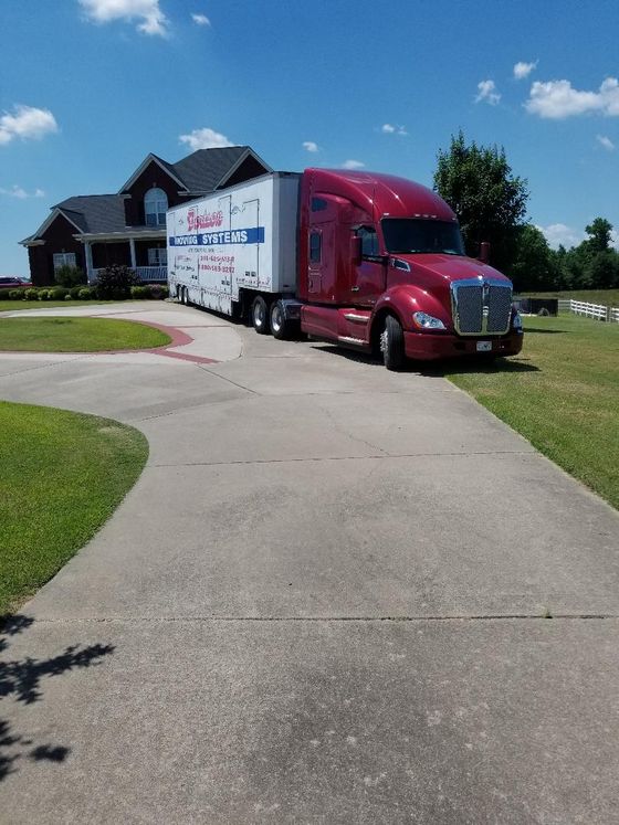 Moving Truck — Red Truck Park in Residential House in Oneonta, AL
