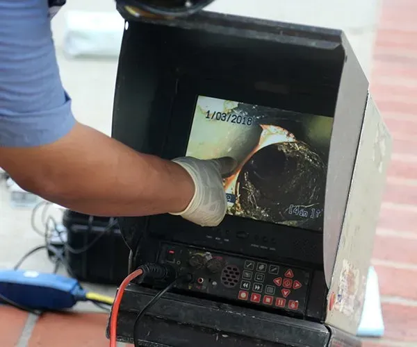 Person Pointing at Screen Showing a Pipe's Interior — SDA Plumbing in Alice Springs NT