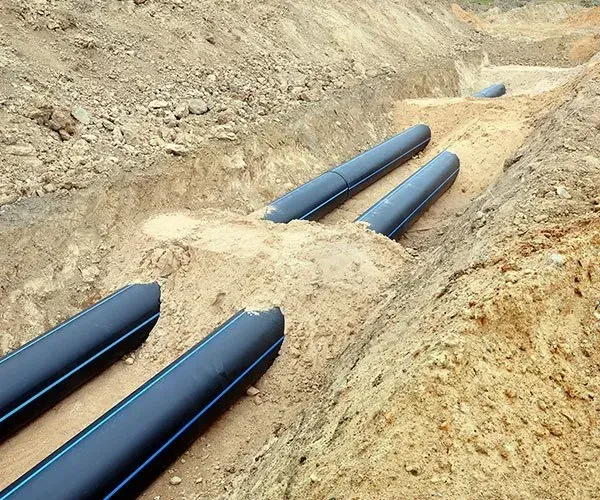 Black Pipes Laid in Trenches Dug in The Construction Site — SDA Plumbing in Alice Springs, NT