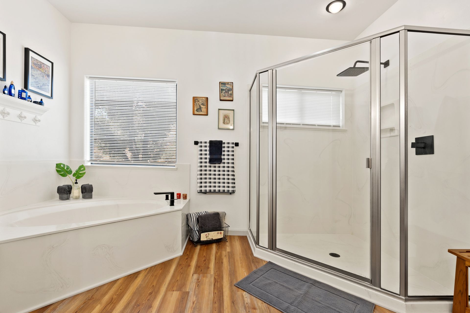 Modern bathroom with frameless shower doors and a large corner glass shower enclosure.