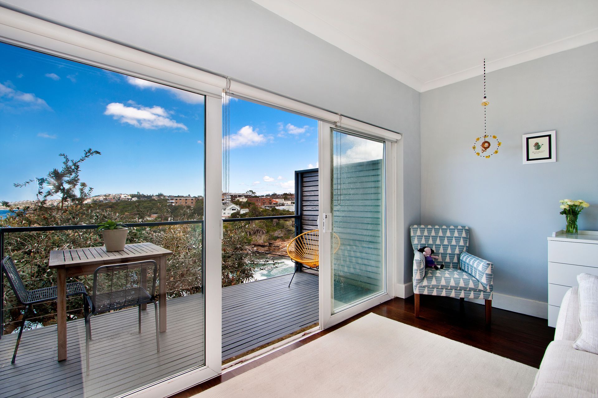 A modern living room with sliding glass doors opening to a balcony