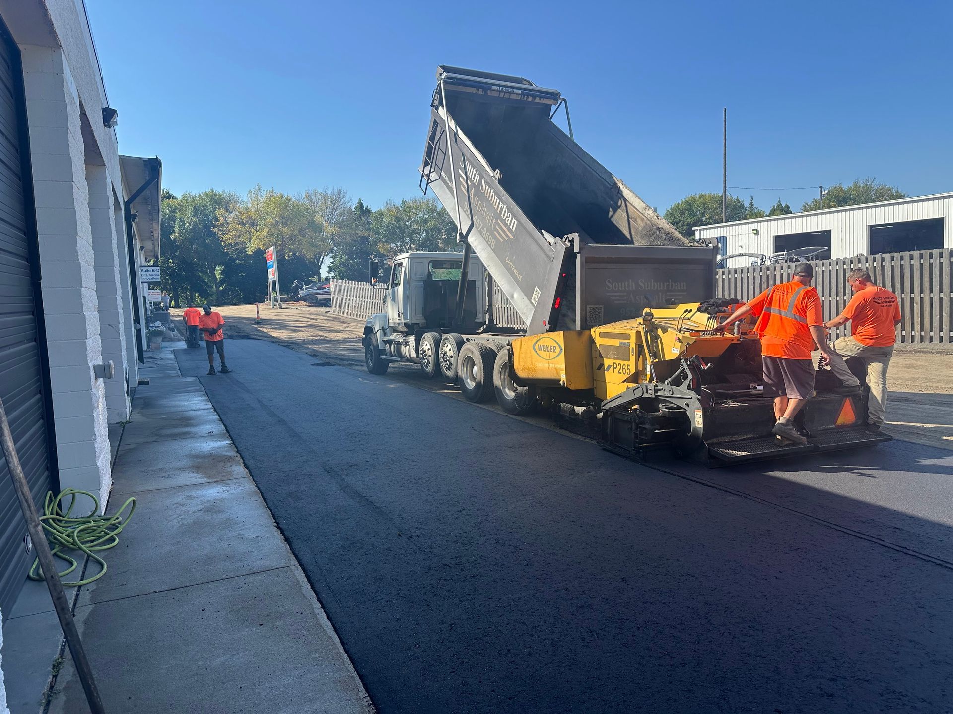 A group of construction workers are working on a road.