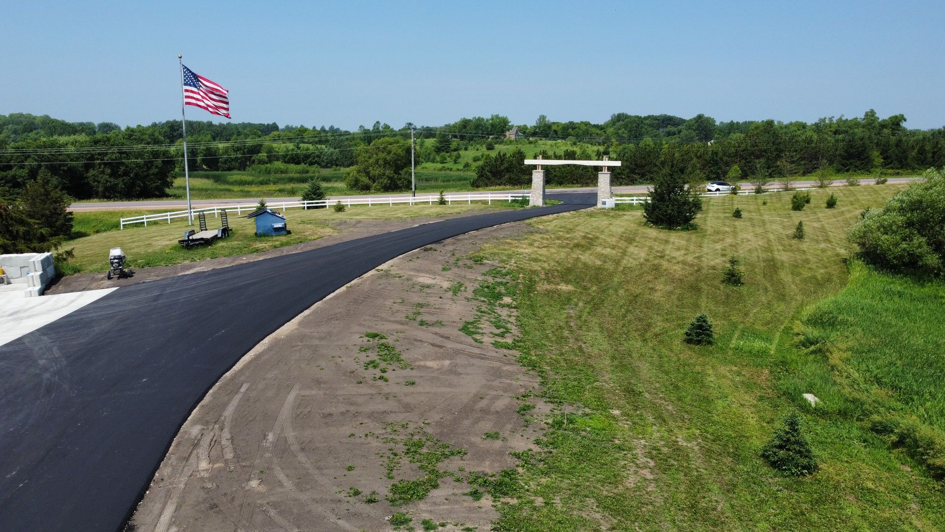 An aerial view of a road with a flag on the side of it.