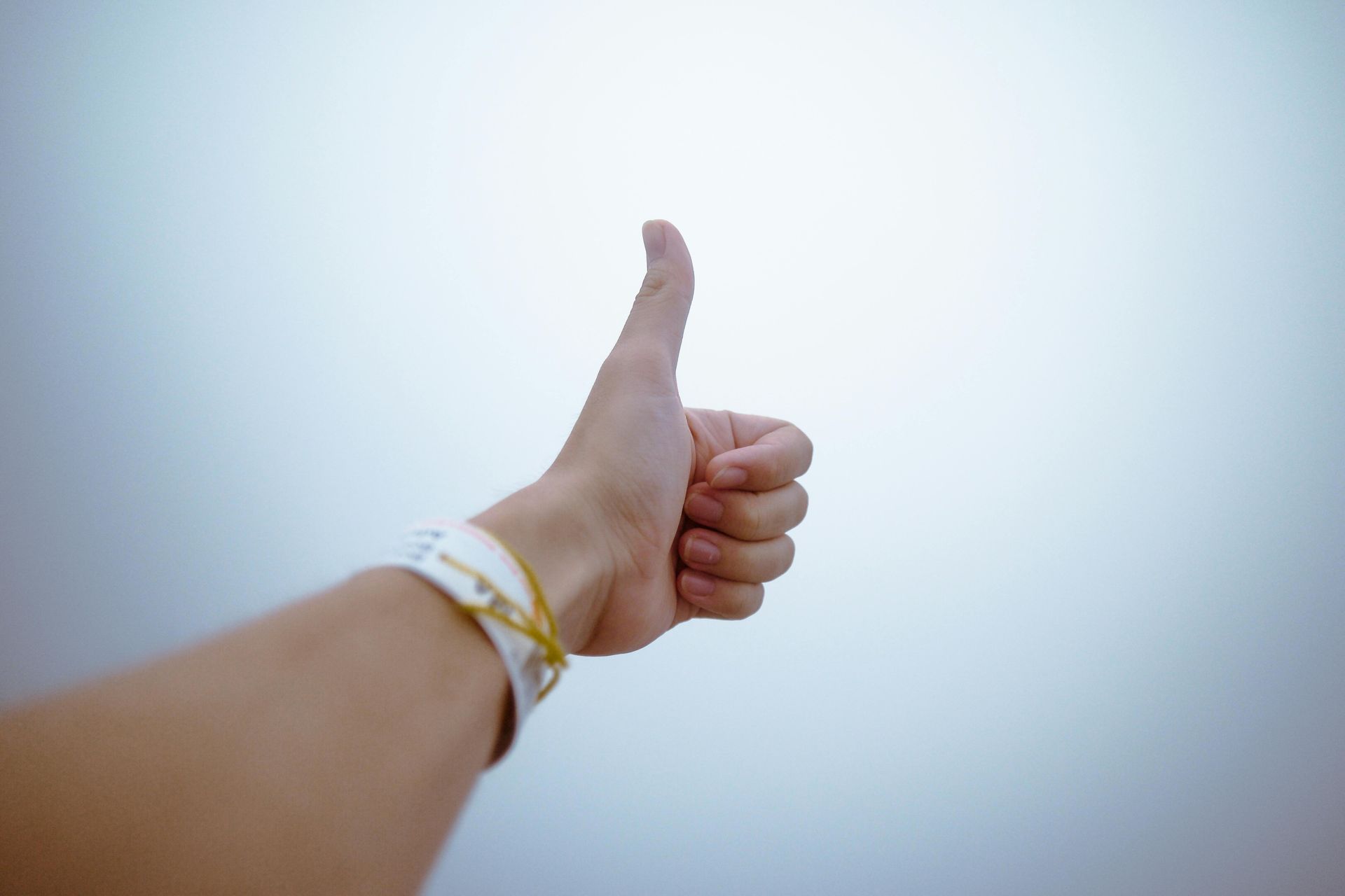 A person is giving a thumbs up sign with their hand.