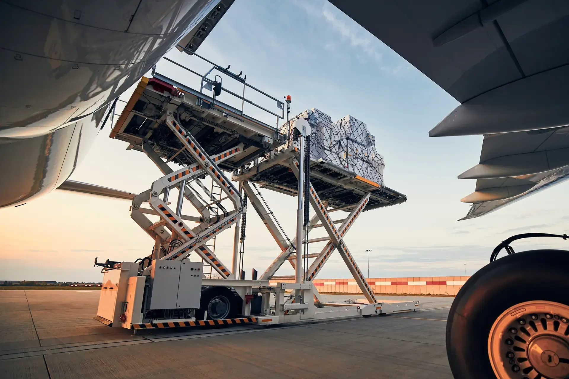 An airplane is being loaded with cargo on a runway.