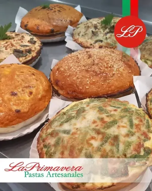 Pastelería variada en exposición, con semillas de sésamo y verduras. Logotipo de