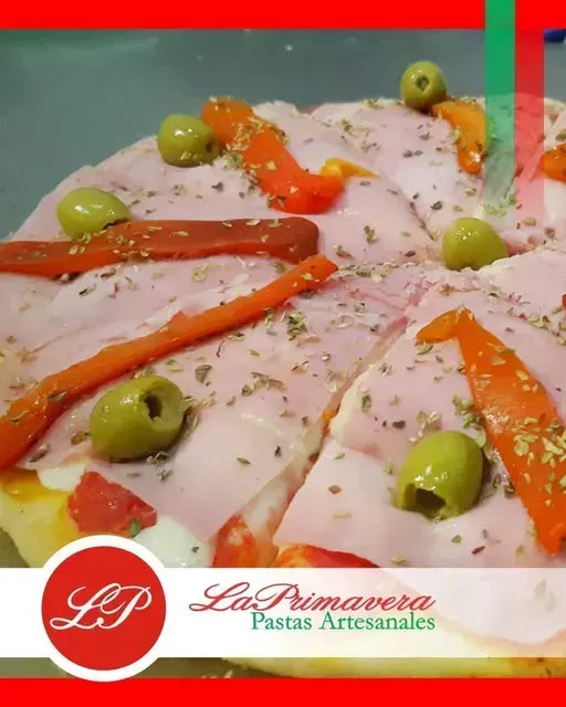 Pizza with ham, olives, and red peppers; logo of