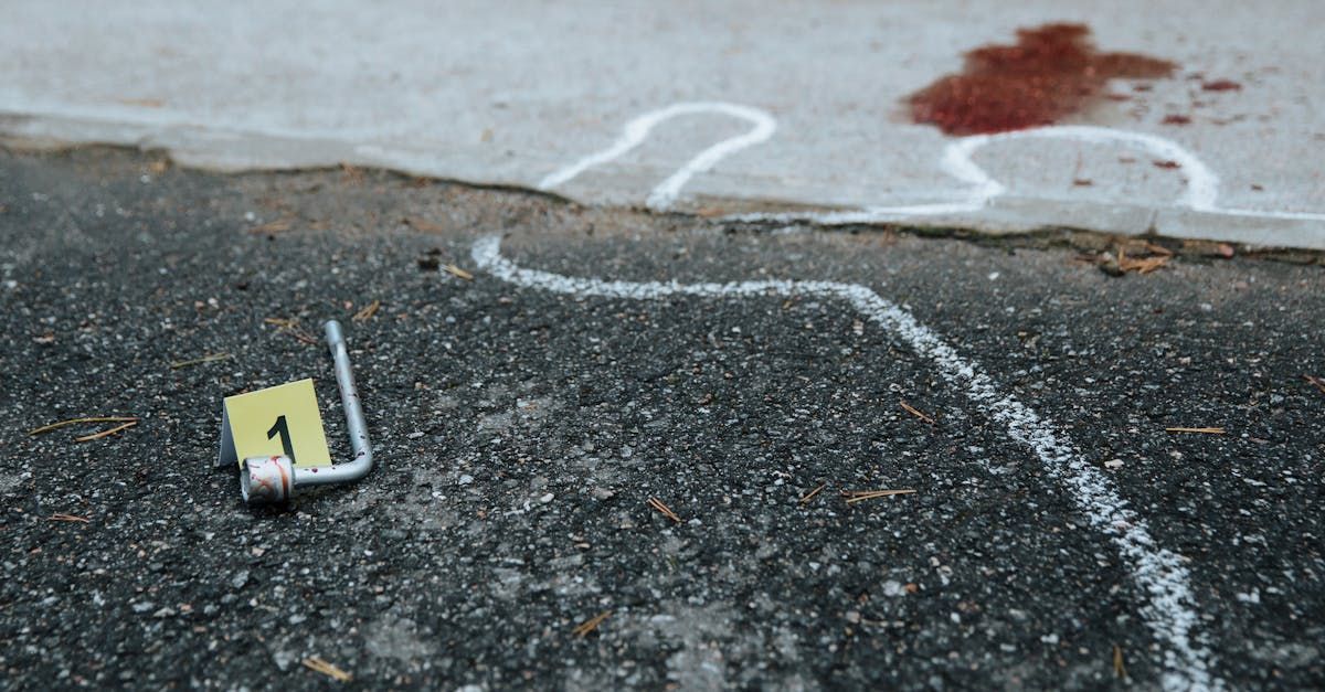A white line is drawn on the ground next to a yellow tag with the number 1 on it.